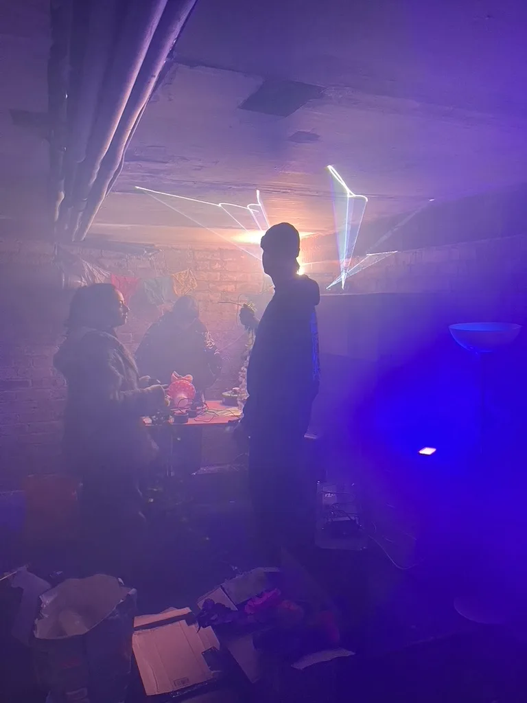 Purple light and laser haze inside the Secret Garden basement